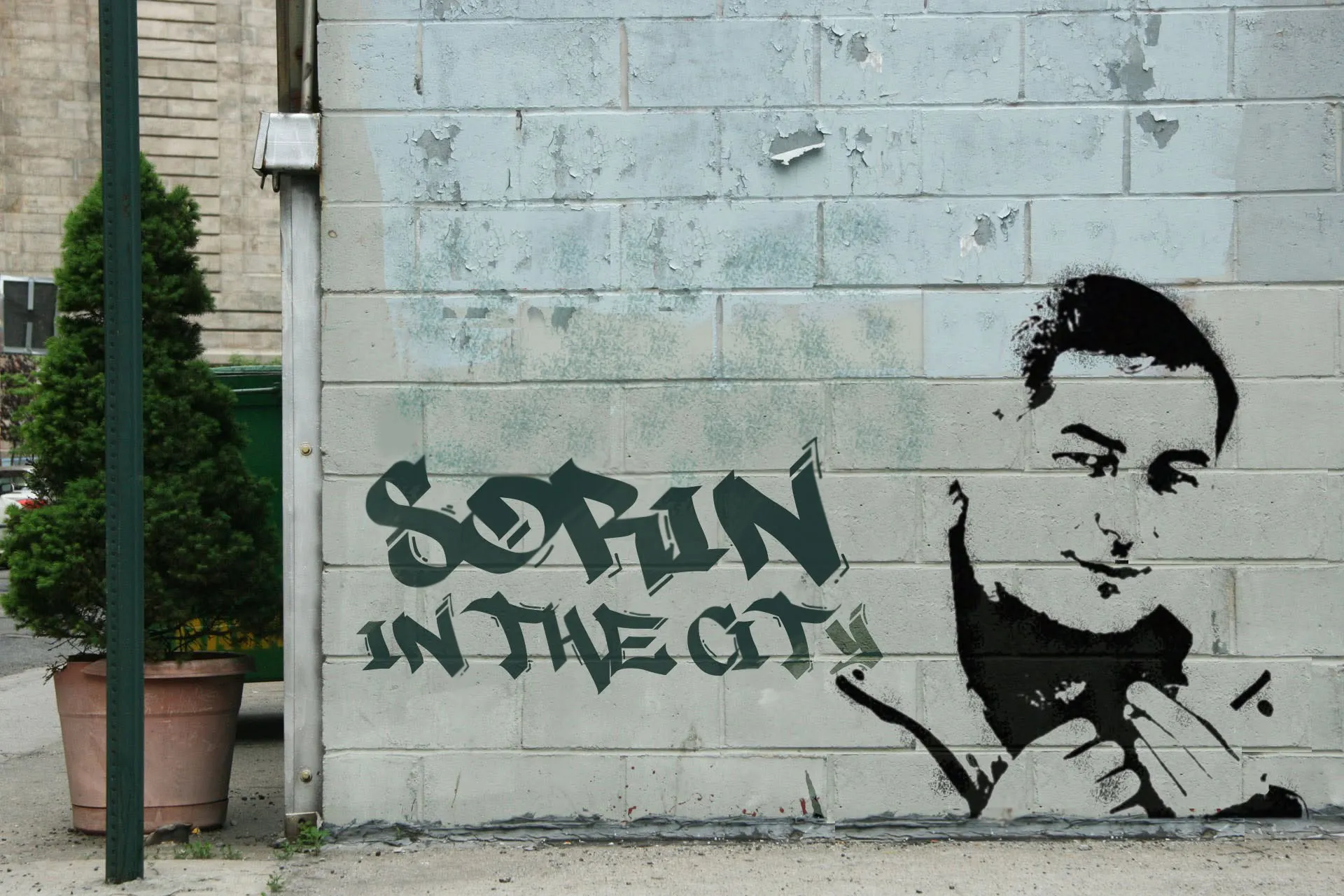 A stencil mural reading 'Sorin in the City' on a brick wall